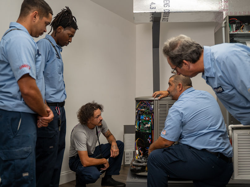 AS-Air-Conditioners-808×606 Air Squid HVAC team looking at air conditioner unit