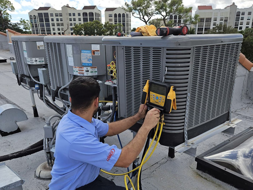 AS-VIP-Maintenance-808×606 Air Squad technician testing air conditioner unit on roof